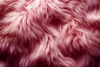 Luxurious pink faux fur texture background with soft fluffy pattern and wavy strands. Natural looking synthetic material close up for fashion design.