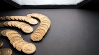 Wooden heart-shaped tokens arranged in curved lines on dark surface, representing love, charity, or community support for fundraising and social causes.