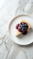 Slice of cheesecake topped with fresh blueberries and berry sauce on white plate over marble surface for dessert menu and bakery advertising.
