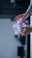 Male professional in light blue shirt holding glowing neon network wireframe between hands, representing digital connectivity, artificial intelligence, and technology innovation for business and corporate applications.