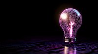 Glowing purple light bulb with disco ball texture reflecting on dark surface creates futuristic mood for creative technology and innovation concepts.