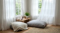 Cozy bedroom corner with natural light streaming through white curtains, wooden nightstand, soft textiles and plants creating peaceful atmosphere.