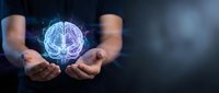 Hands holding glowing brain hologram representing artificial intelligence, neural networks, and digital innovation for technology and science concepts.