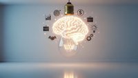Glowing brain lightbulb with business icons floating in modern room representing innovation, creativity and intelligent solutions for corporate success.
