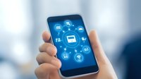 Hands holding smartphone displaying glowing blue network of connected digital communication icons and symbols for mobile technology concept.