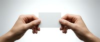 Two hands holding blank white business card mockup against clean background for branding and corporate identity design projects.