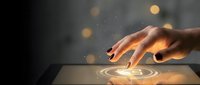 Hand touching glowing digital interface with ripple effect and bokeh lights on dark background for technology and innovation concepts.