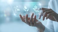Hands holding transparent screen with renewable energy, water conservation, green building icons, showcasing sustainable technology concept.