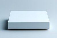 Minimalist white square podium on light background with soft shadow, clean geometric platform for product display and presentation purposes.