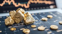 Golden nuggets and coins on financial chart background showing market trends and investment analysis for precious metals trading and commodities market.