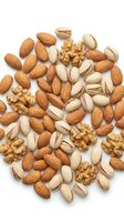 Mixed nuts collection with almonds, walnuts and pistachios scattered on white background for healthy snacking and cooking recipes.
