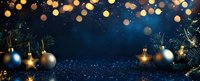 Christmas ornaments and pine branches on dark blue background with golden bokeh lights and glitter. Festive holiday decoration for greeting cards.