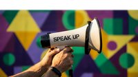 Hands holding a megaphone with speak up text against colorful geometric background, symbolizing voice, protest, and social activism.