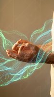 Human hands cupping glowing digital data streams with flowing particles representing technology innovation and digital transformation concepts.