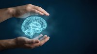 Male hands protecting glowing digital brain hologram on dark blue background representing mental health care, neuroscience research and cognitive protection concepts.