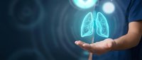 Medical professional holding glowing lung hologram in palm, healthcare technology concept for respiratory medicine and pulmonology treatment innovation.