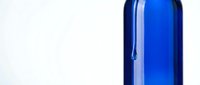 Blue glass bottle isolated on white background, suitable for beverage, cosmetic, and pharmaceutical packaging design projects.
