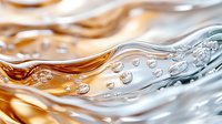 Flowing liquid waves in orange and blue colors with air bubbles creating dynamic abstract background pattern with transparent fluid motion effect.