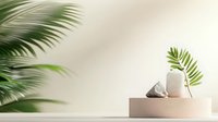 Minimalist podium display with palm leaves and geometric decorative objects on beige platform against neutral wall background. Suitable for product presentation.