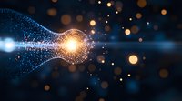 Glowing particles forming light bulb shape against dark background with bokeh effect, symbolizing innovation and creative energy breakthrough.