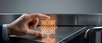 Businessman hand touching glowing orange geometric mandala symbol on digital tablet screen, representing innovation, technology, and digital transformation in modern business.