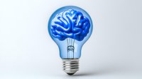 Glowing light bulb with blue brain inside on white background, creative concept for innovation, ideas and intelligence. Isolated object for design projects.