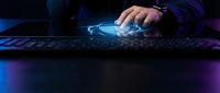 Male hand pressing glowing blue fingerprint scanner on dark keyboard, cybersecurity biometric authentication concept for technology and data protection.