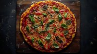 Fresh homemade pizza with crispy crust topped with tomato sauce, melted mozzarella, mushrooms and fresh basil leaves on rustic wooden cutting board against dark background.