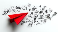 Red paper airplane with hand drawn business doodles and sketchy arrows trailing behind on white background, representing leadership and creative direction.
