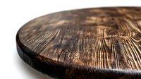 Rustic round wooden cutting board with distinctive wood grain texture and dark brown finish photographed at angle showing surface detail and edge.