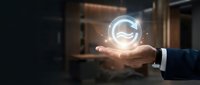 Businessman holding glowing thumbs up icon in palm, representing positive feedback, customer satisfaction, and approval in digital business communication.
