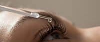 Professional cosmetic treatment with dermal filler injection near eye area for anti-aging skincare and beauty enhancement procedures.