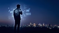 Businessman silhouette analyzing digital data interfaces against city skyline at night. Technology innovation and business analytics concept for presentations.