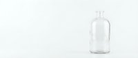 Clear glass bottle with white cap isolated on white background for product mockup and packaging design projects.