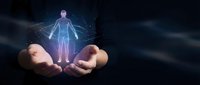 Hands holding glowing human hologram with energy connections representing digital health technology, medical innovation and futuristic healthcare concepts.