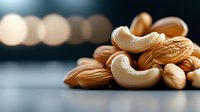 Mixed nuts on dark background with bokeh lights, featuring raw cashews and almonds in macro photography. Fresh organic protein-rich snack for healthy eating.