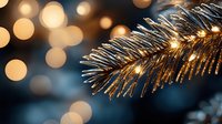 Festive pine branch with golden lights and bokeh background creating magical holiday atmosphere for Christmas decorations.