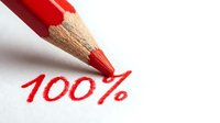 Red colored pencil writing 100% text on white paper surface showing complete success achievement and maximum performance rating for business goals.