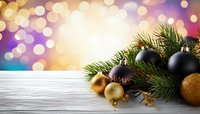 Christmas ornaments and pine branches on white wooden surface with colorful bokeh background for holiday greeting cards and festive designs.