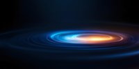Glowing spiral of blue and orange light against dark background creates dynamic motion effect, suitable for science and technology concepts and presentations.