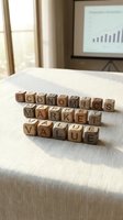 Wooden letter blocks spelling economics market value on conference table with presentation screen in background for business education concepts.