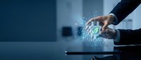 Business professional using futuristic holographic interface with digital icons and data visualization technology in modern office environment.