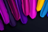 Vibrant feathers in purple, pink, and blue tones arranged on dark background create dramatic contrast and modern abstract composition for creative designs.