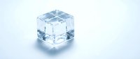 Single transparent ice cube with crystal clear edges and realistic water droplets on clean white background for beverage and cooling concepts.