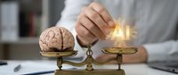 Professional balancing human brain and glowing AI chip on golden scales representing artificial intelligence versus human intelligence comparison.