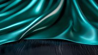 Luxurious turquoise silk fabric with soft folds and waves creates dramatic contrast against dark textured surface, suitable for fashion and luxury product backgrounds.