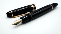 Two black fountain pens with gold accents, one capped and one uncapped showing the nib, isolated on white background for design and writing projects.