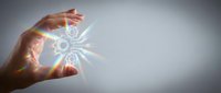 Hands protecting glowing gear mechanism with light rays symbolizing innovation, technology protection, business strategy and industrial engineering solutions.