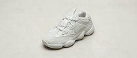 White chunky sneaker with mesh and leather upper, thick sole, isolated on neutral background. Suitable for footwear, fashion, sportswear, and e-commerce design projects.