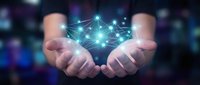 Two hands holding glowing digital network nodes with connecting lines, representing data connectivity, technology innovation, and global communication systems for business solutions.